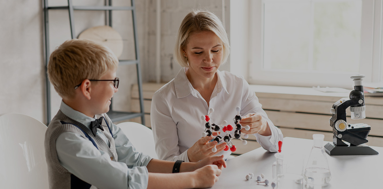 Female science tutor in Indianapolis studying chemistry with student